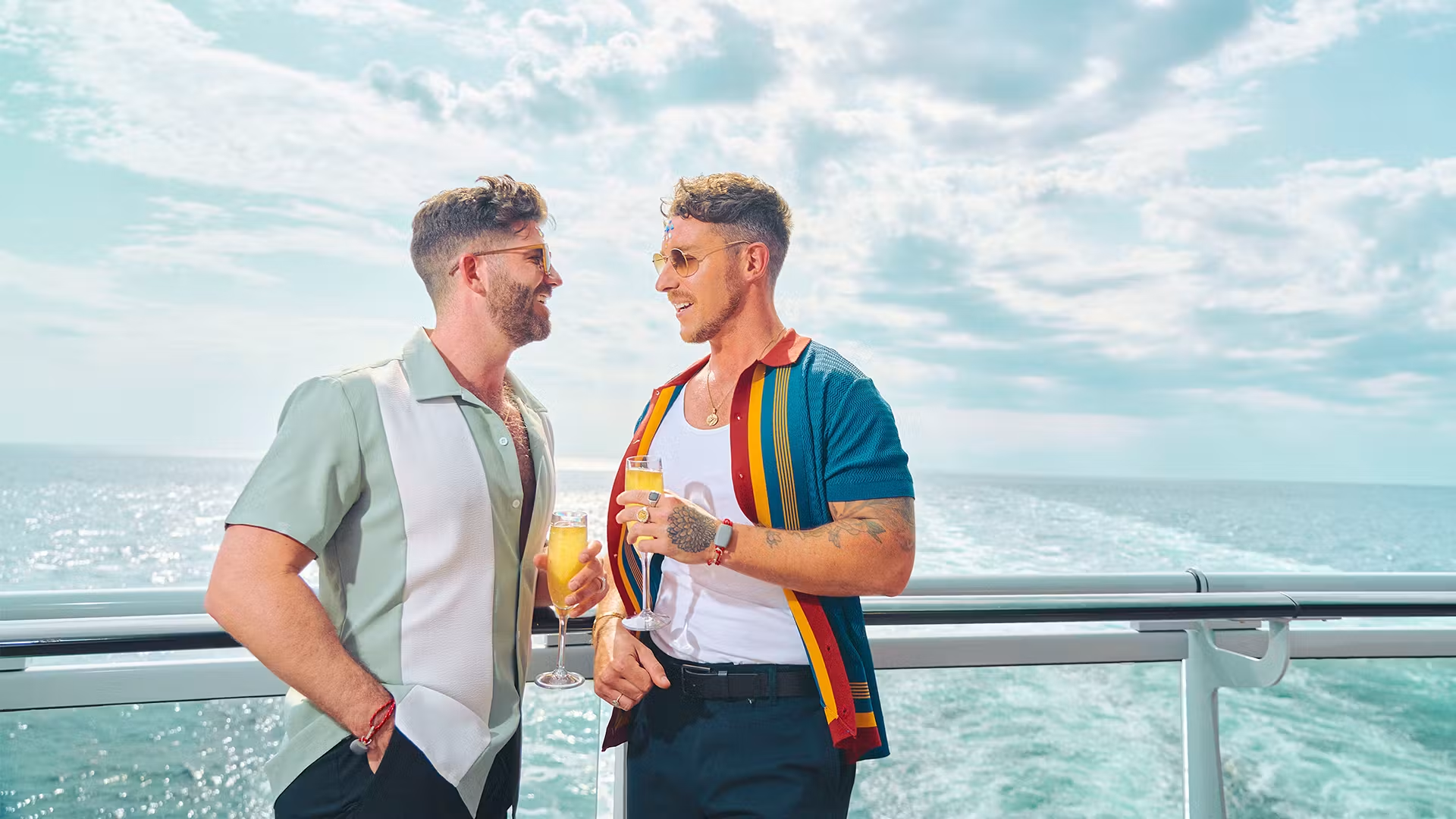 Two men enjoying mimosas on deck